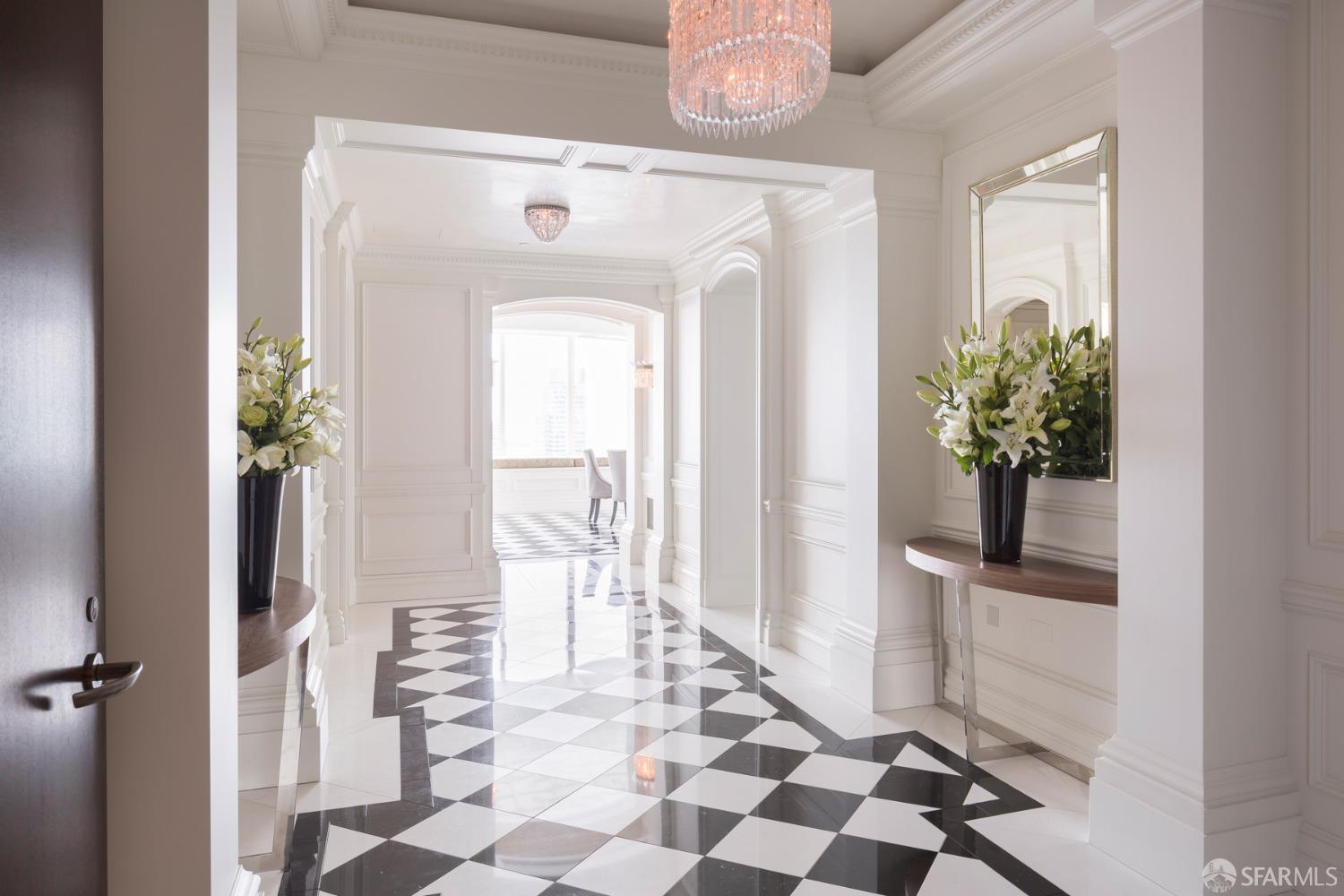 a view of a hallway with wooden floor and a dining room