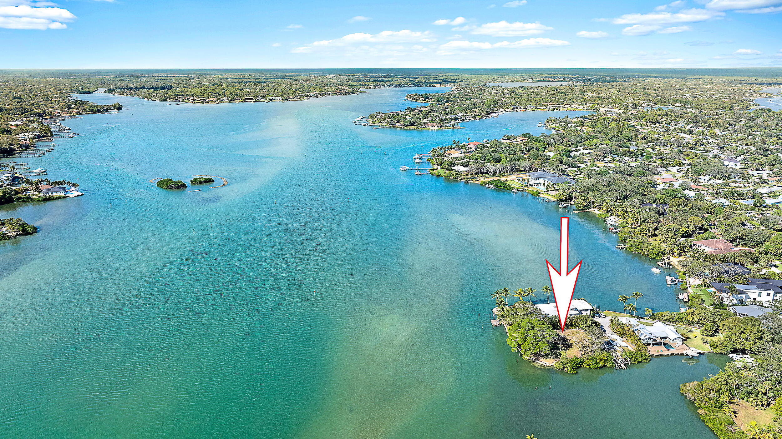 an aerial view of a house with a lake view