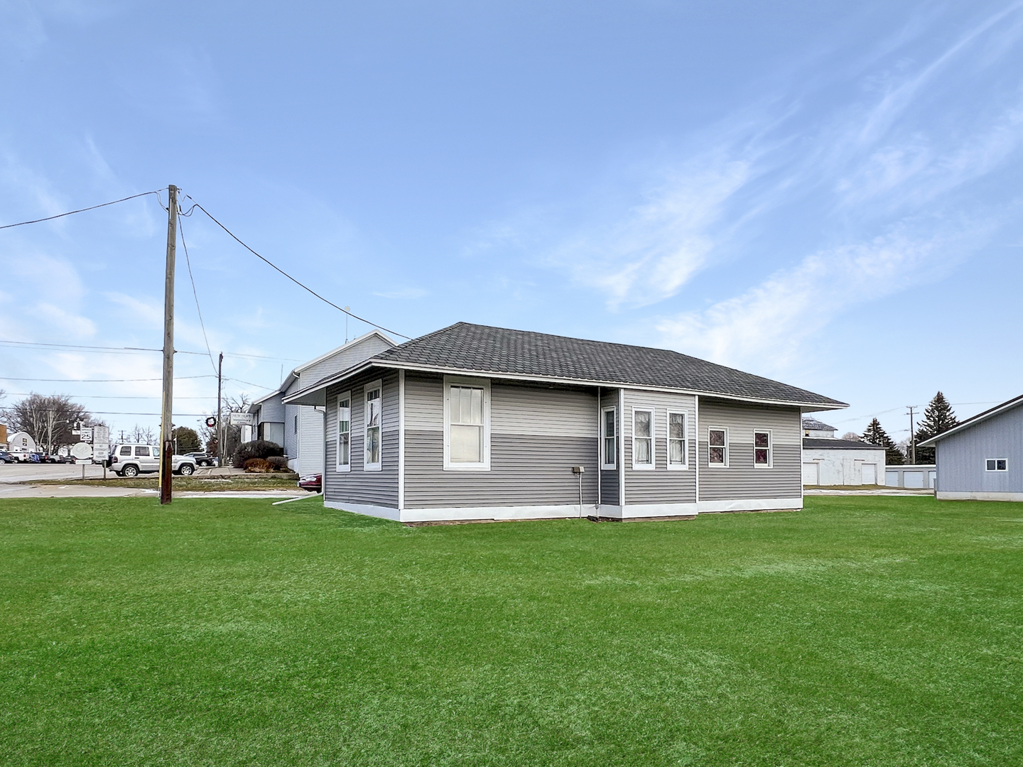 a view of a house with a yard and sitting area