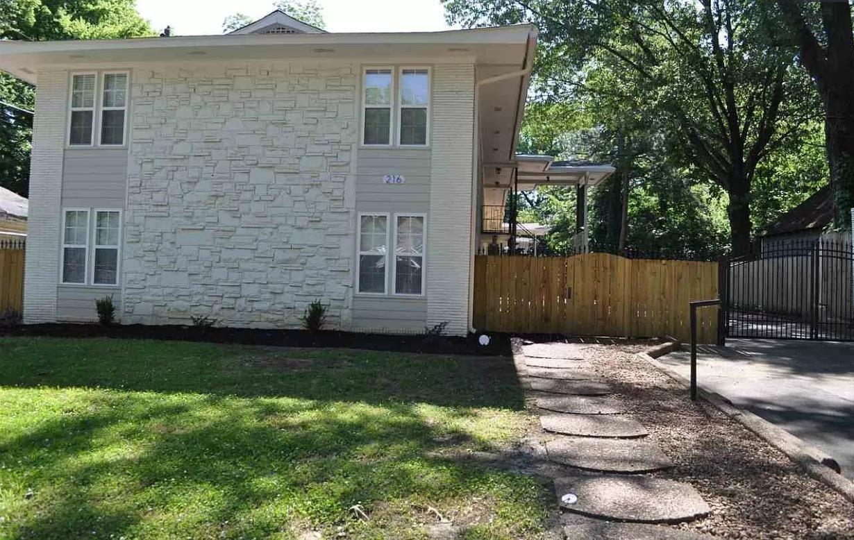 a backyard of a house with wooden fence