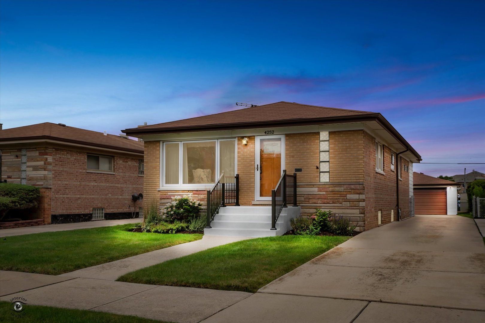 a front view of a house with a garden