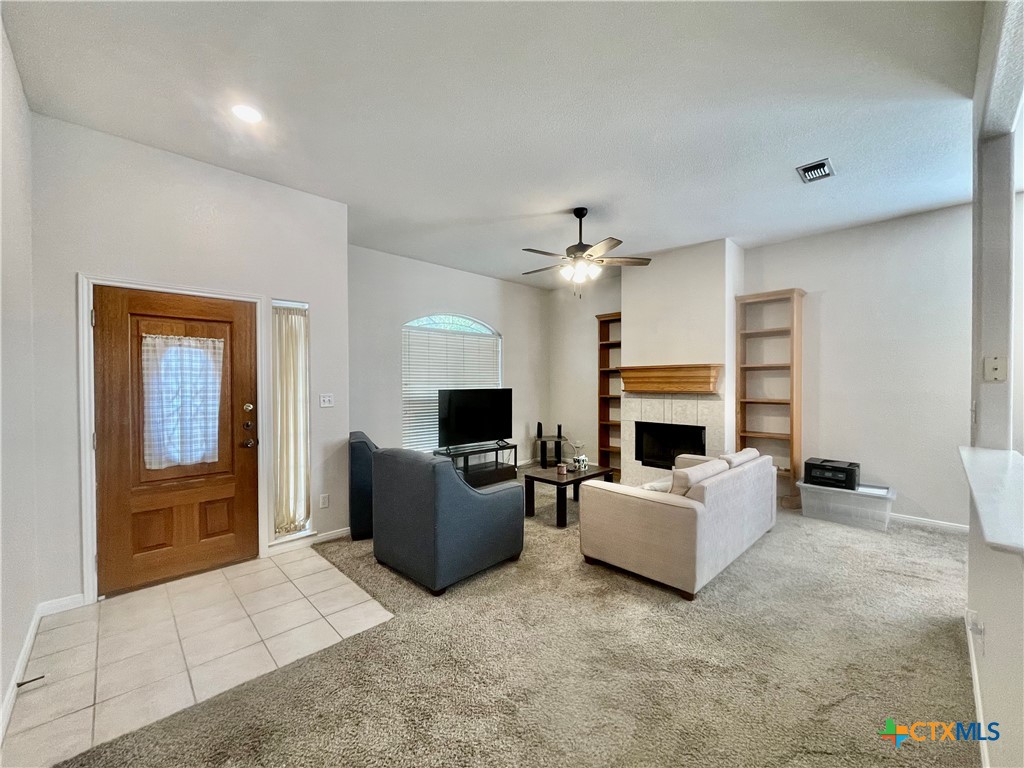 a living room with furniture and a fireplace