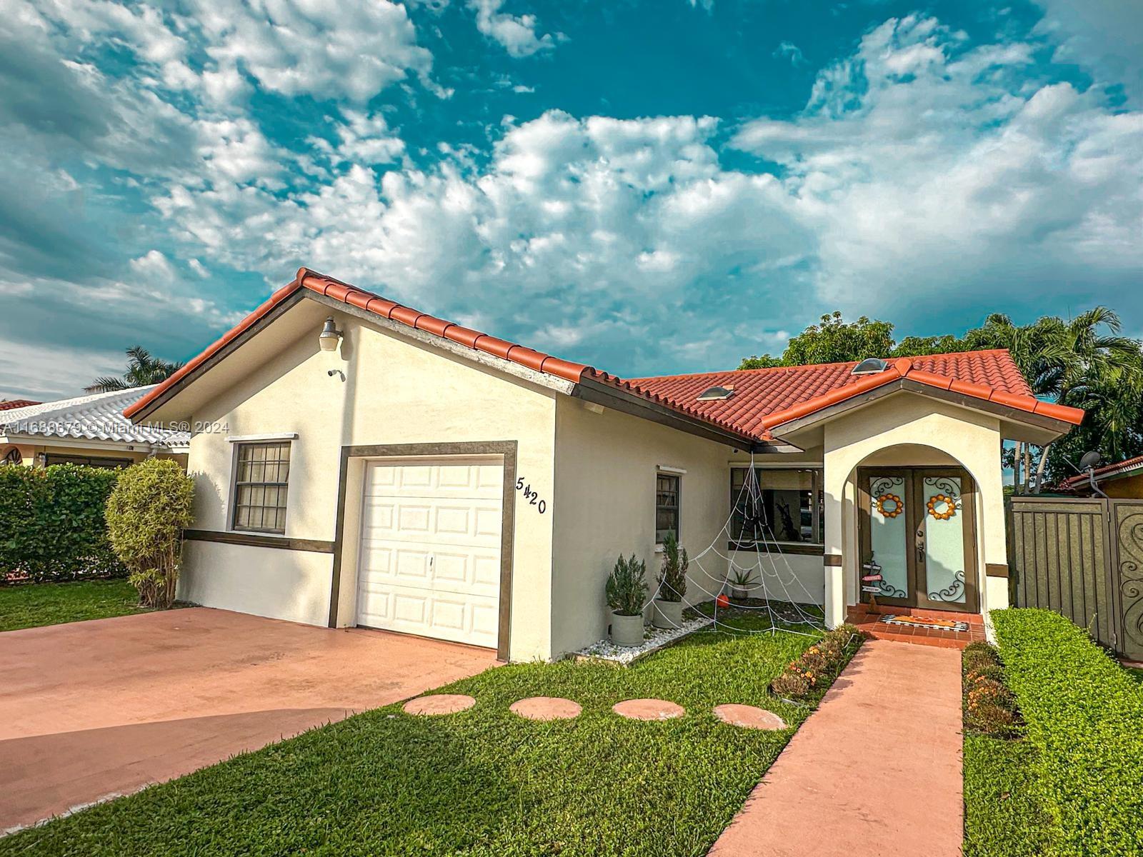 a front view of a house with a yard