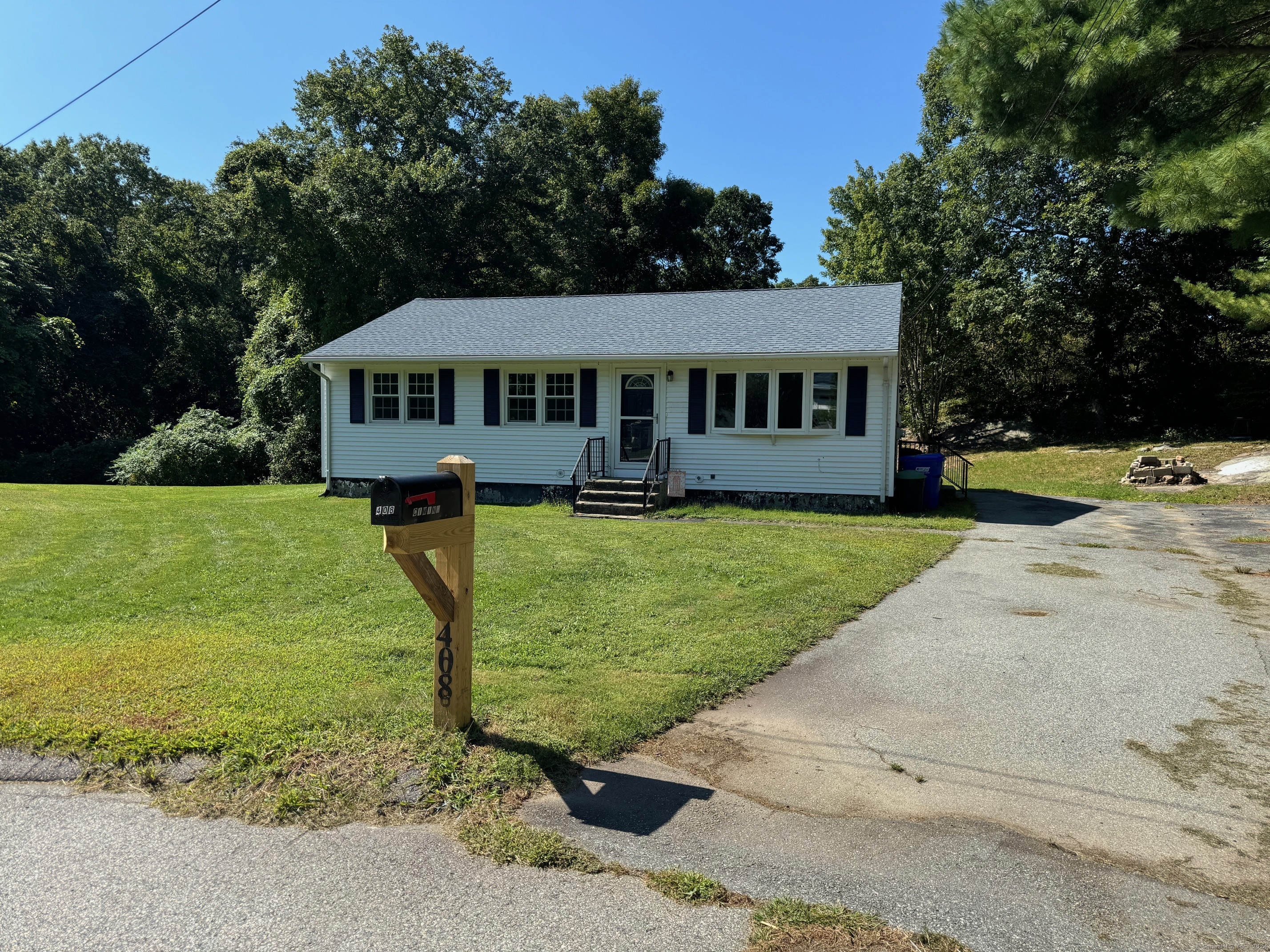 a view of a house with a yard and sitting area