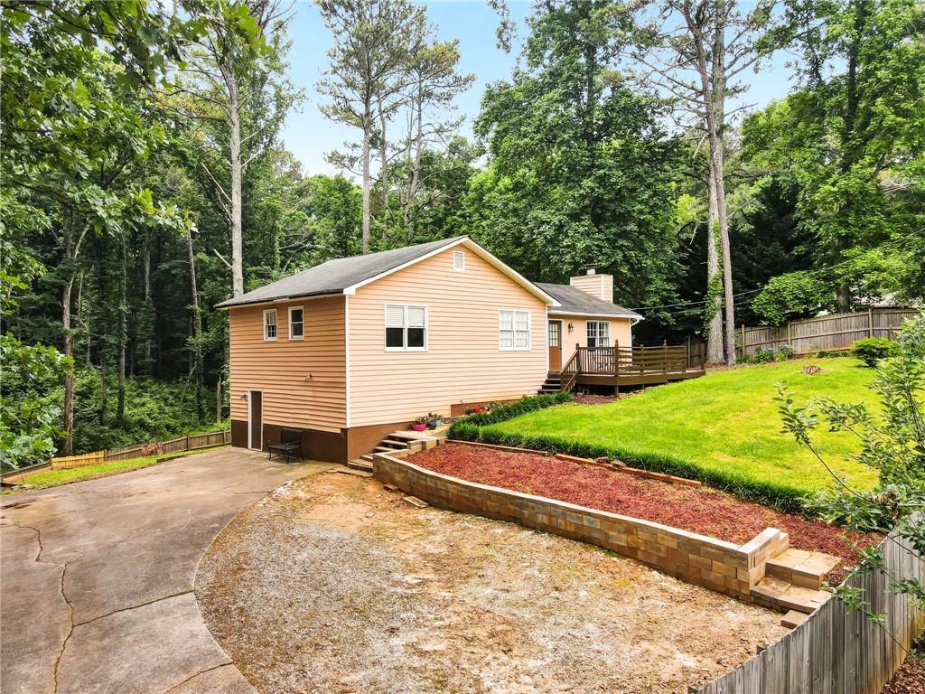 a view of a house with backyard and sitting area