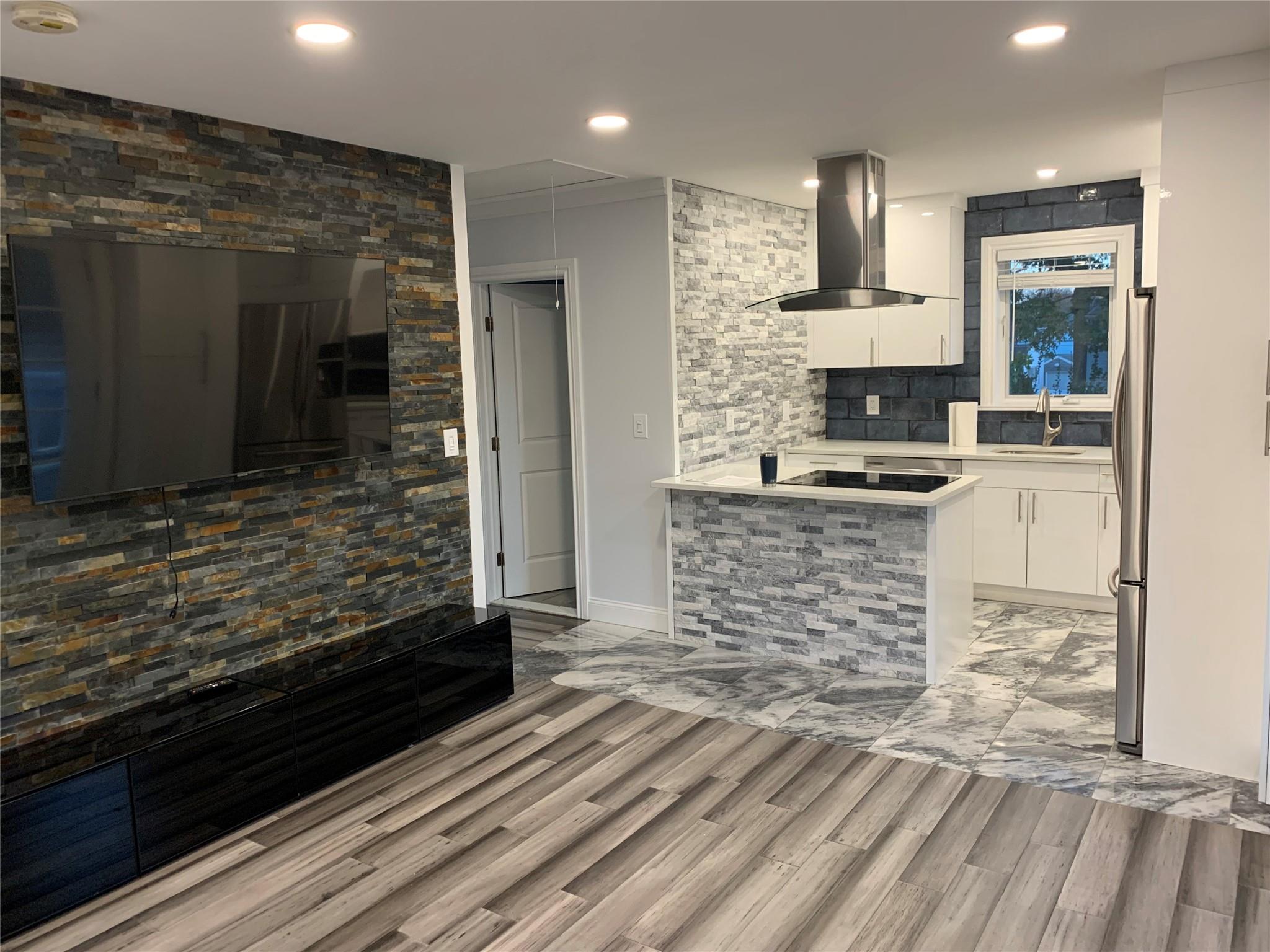 a kitchen with kitchen island granite countertop a stove and a refrigerator