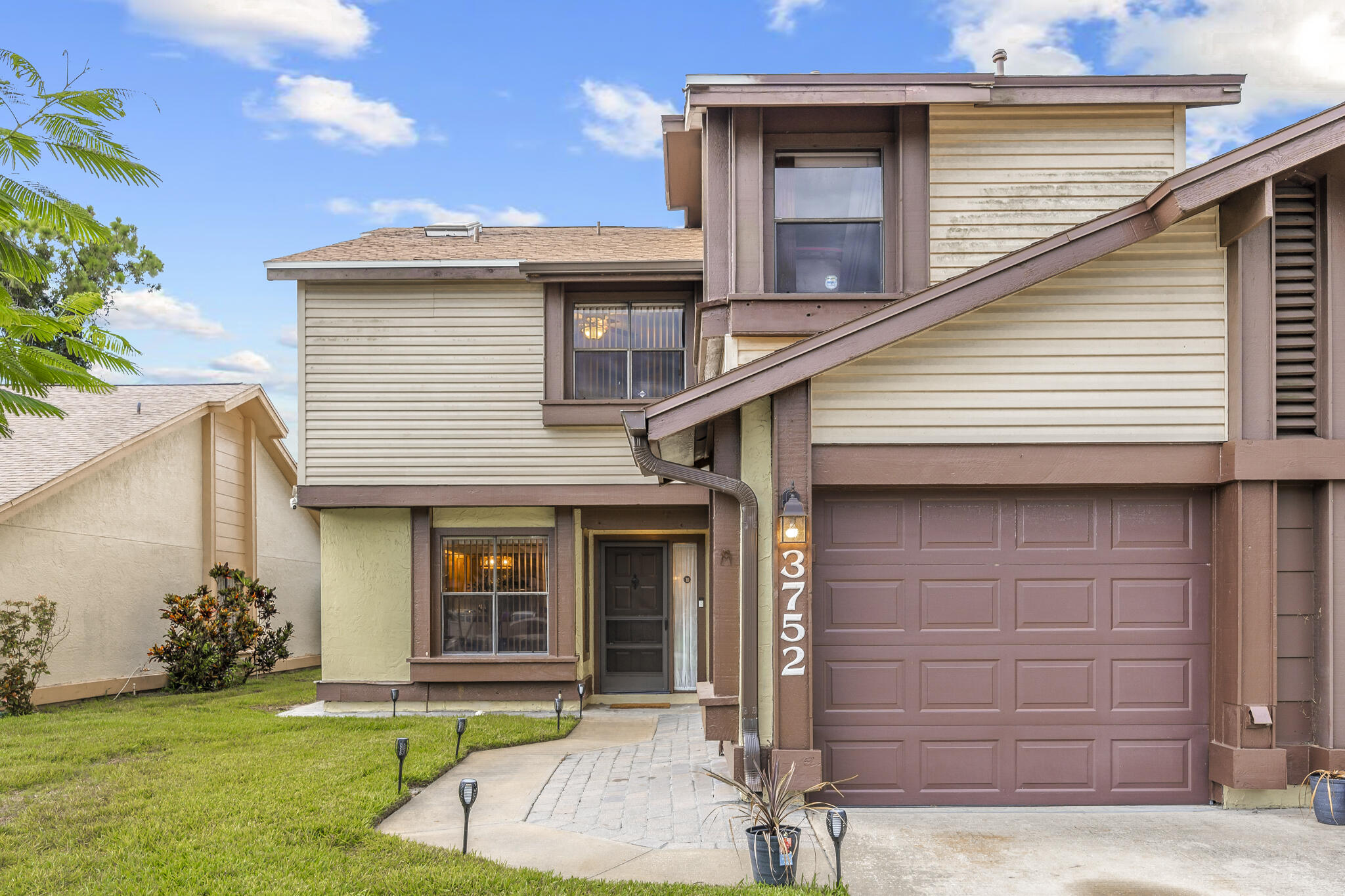 a front view of a house with a yard