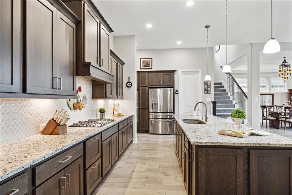 a kitchen with sink stove and cabinets