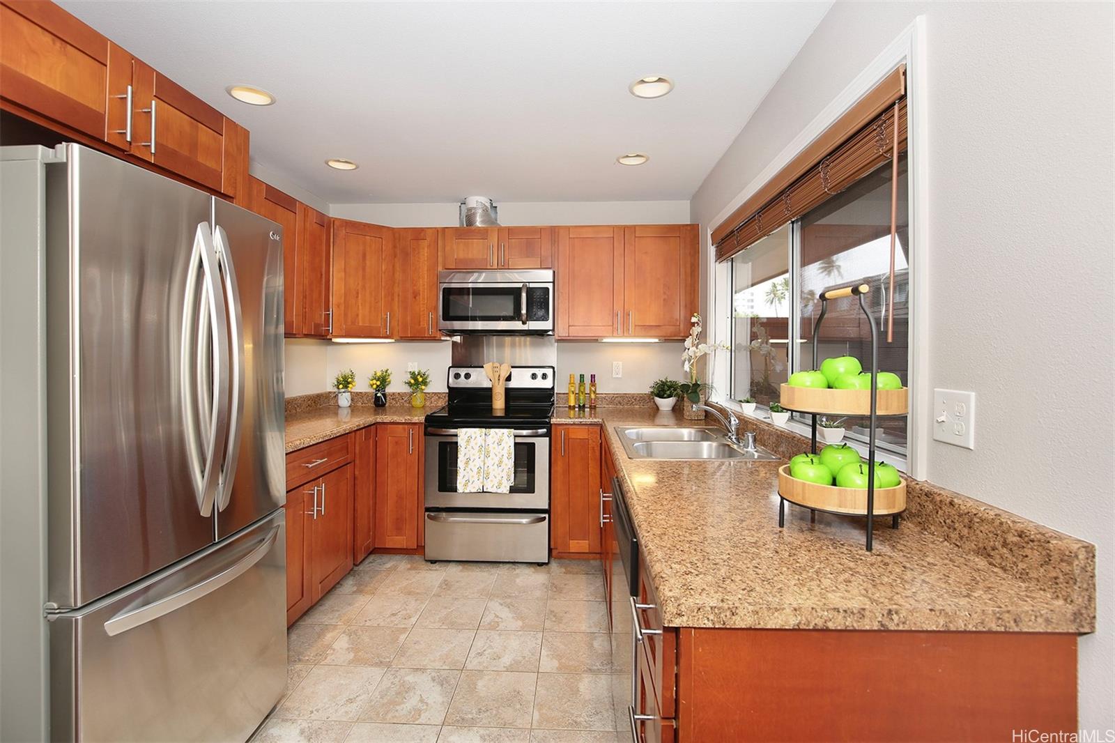 a kitchen with stainless steel appliances granite countertop sink refrigerator and microwave