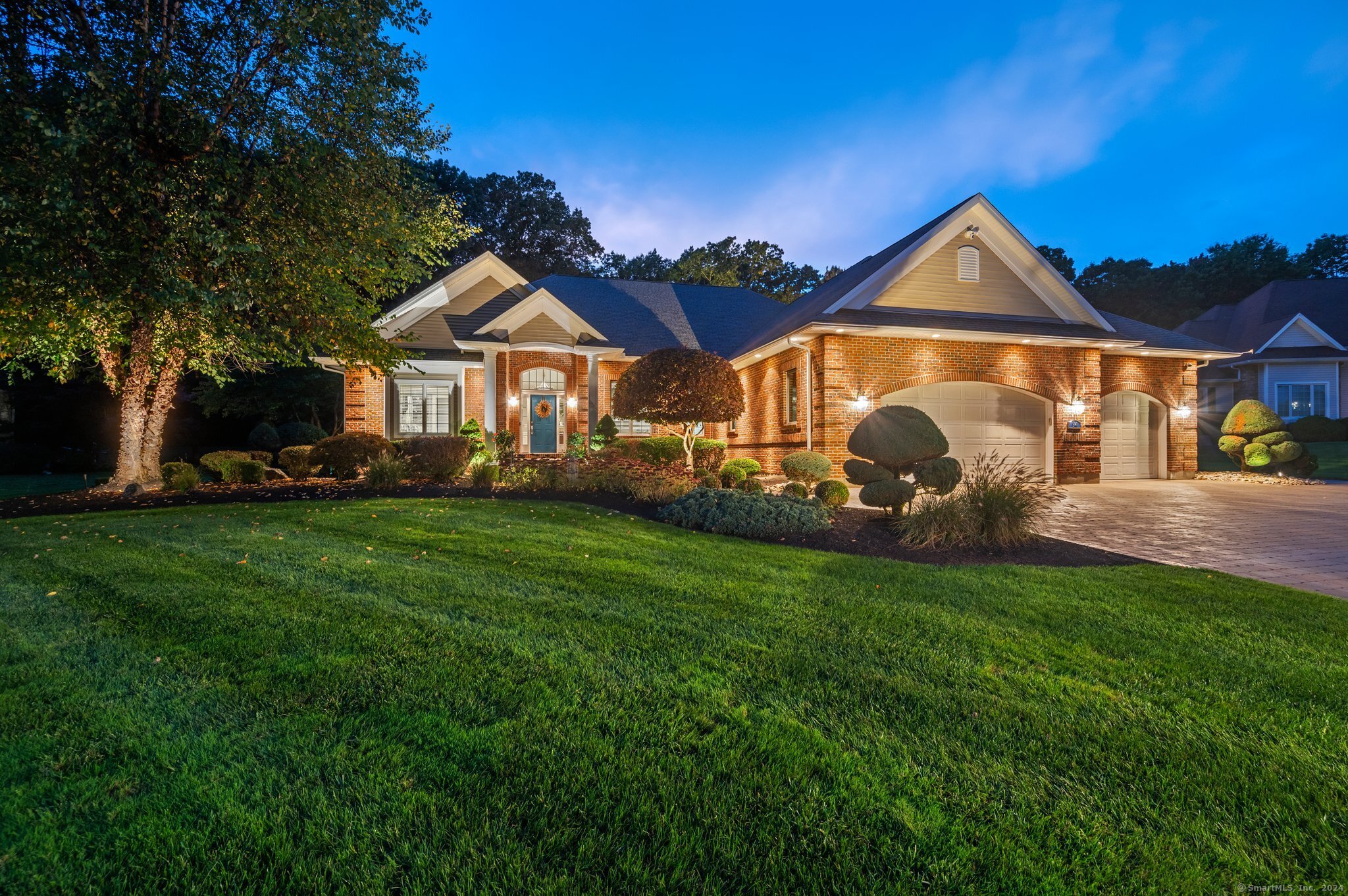 a front view of a house with a garden