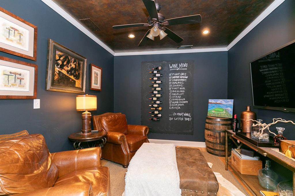 a bedroom with furniture and a flat screen tv