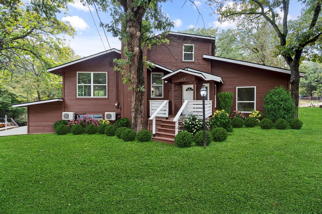 a front view of a house with a garden