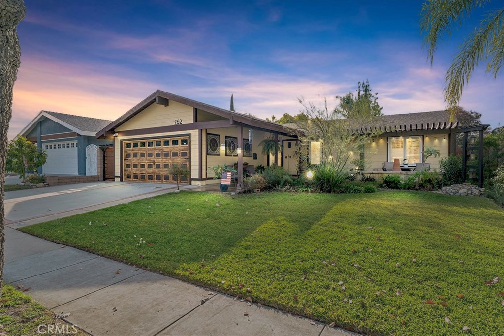 a front view of house with yard and green space