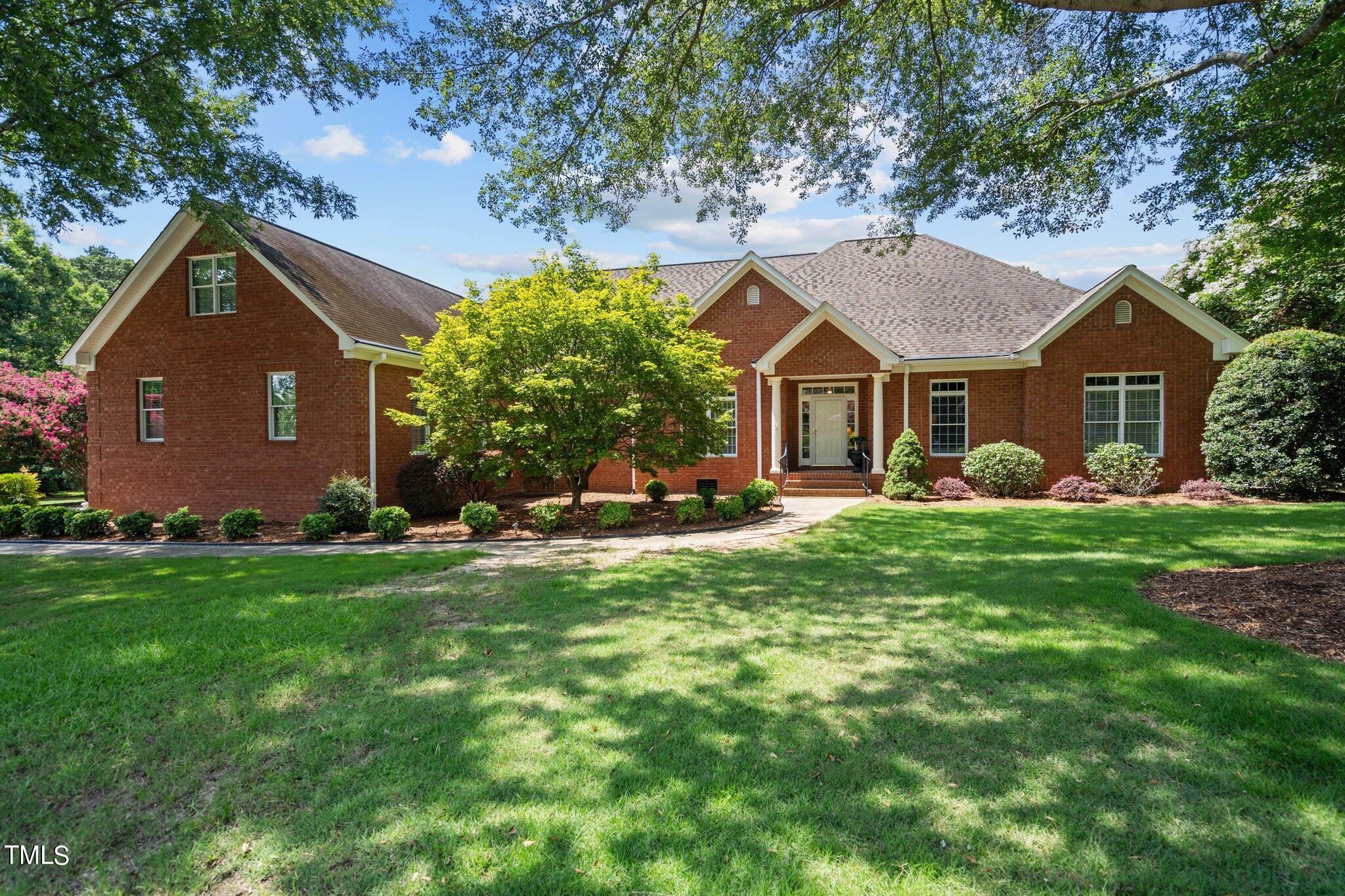 a front view of house with yard and green space