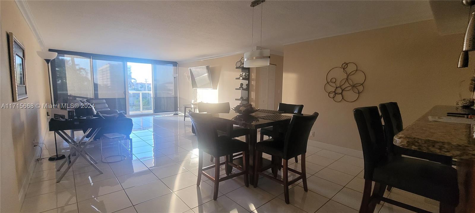 a view of a dining room with furniture and a window