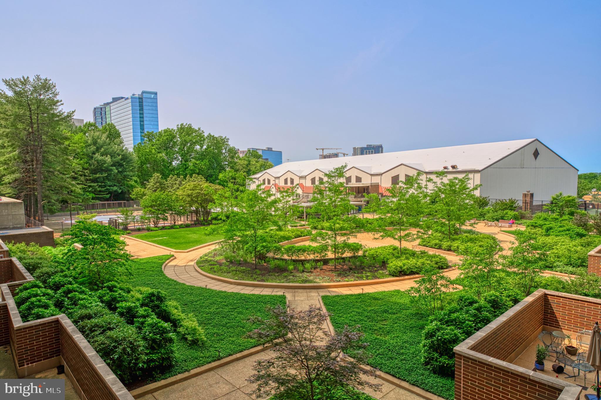 a view of a garden with a building in the background