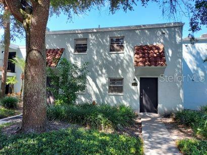 a view of a house with potted plants