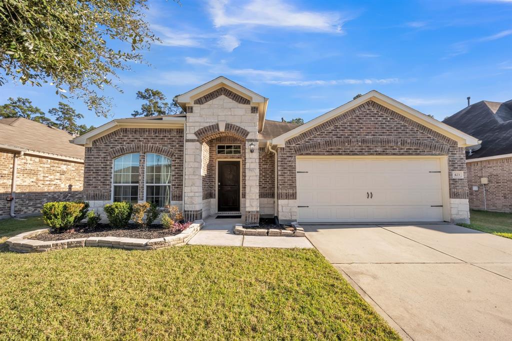 This charming single-story home features a brick exterior with a two-car garage, a well-maintained front lawn, and a welcoming front porch. Ideal for comfortable family living in a friendly neighborhood.