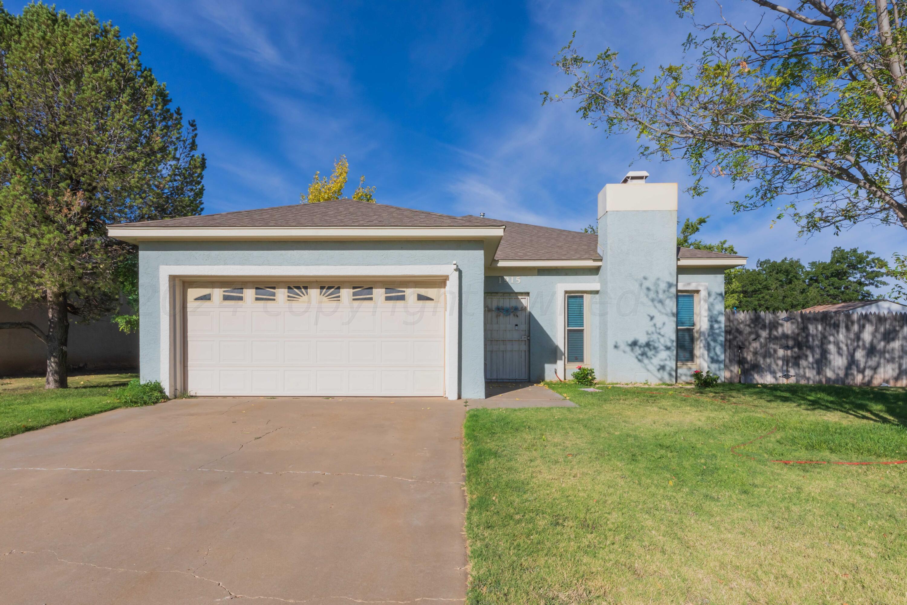 a view of a house with a yard and garage