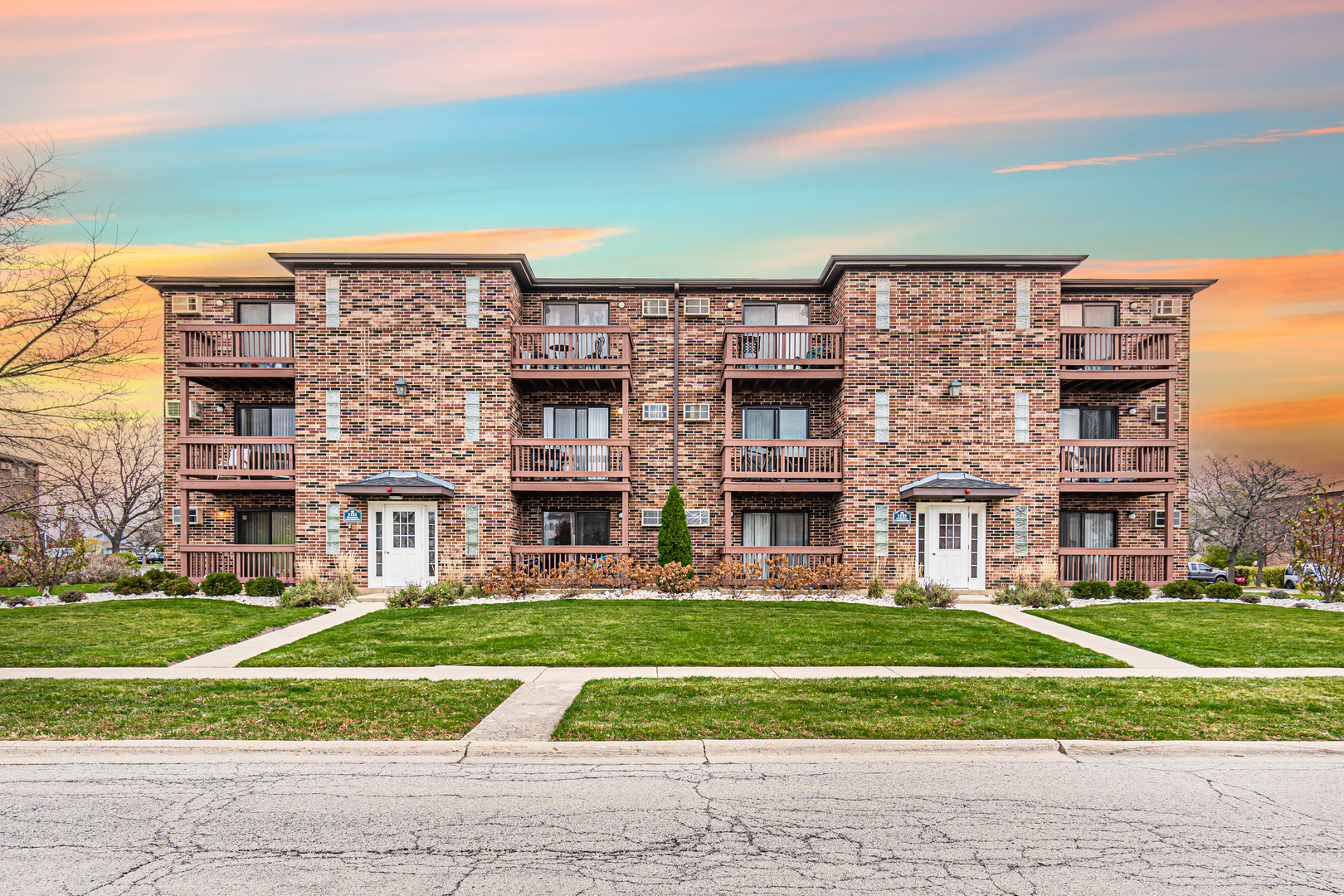 a view of building with yard in front of it