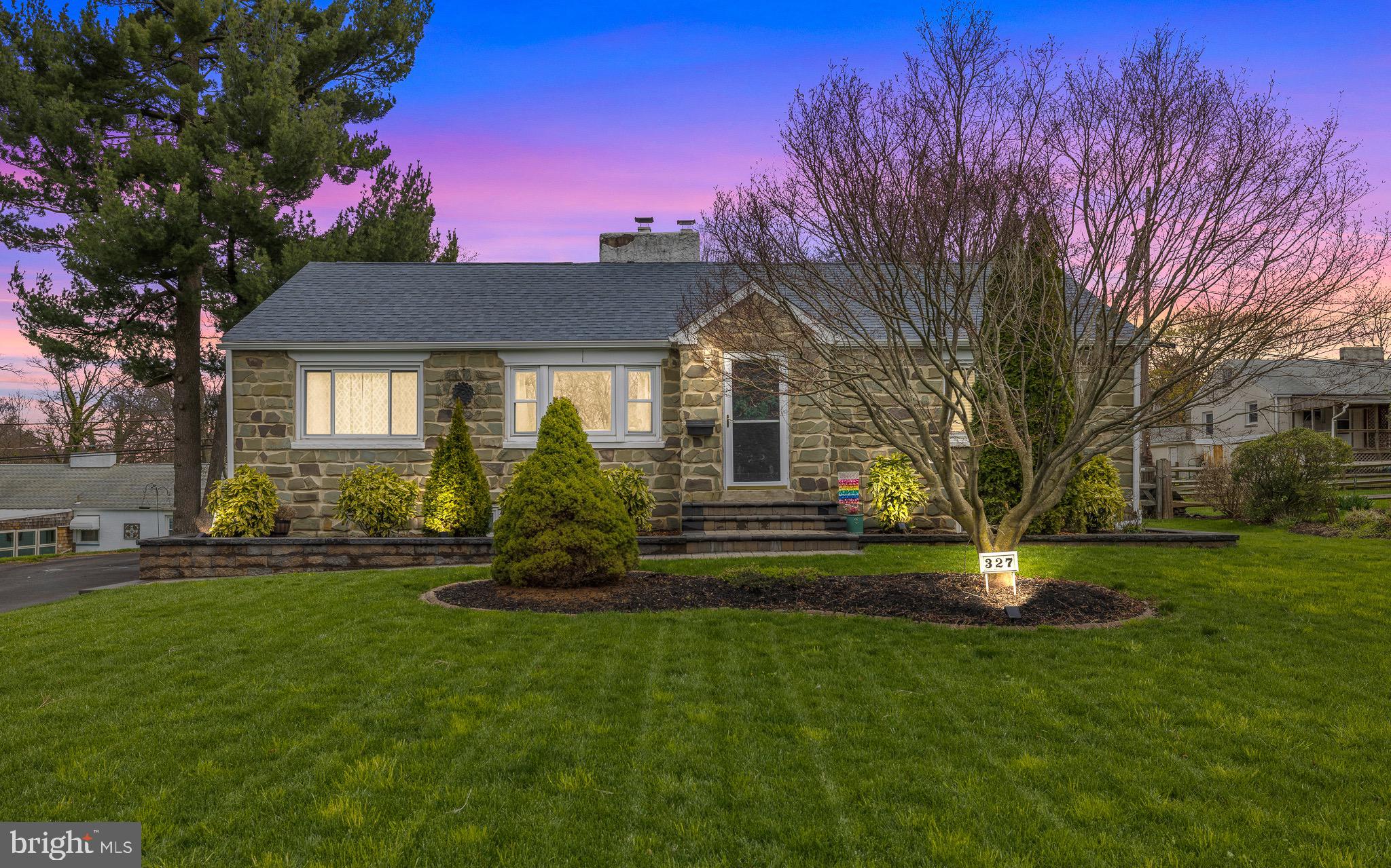 a front view of a house with a garden