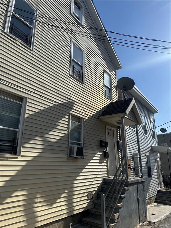 View of side of property with cooling unit