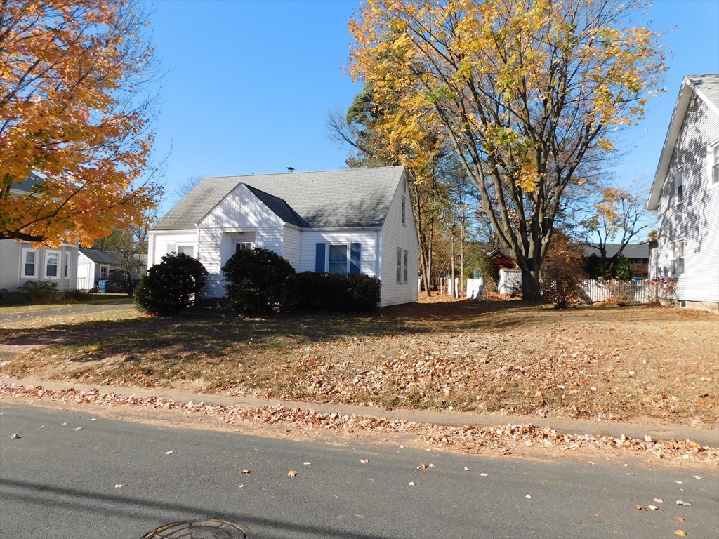 a front view of a house with a yard covered with snow