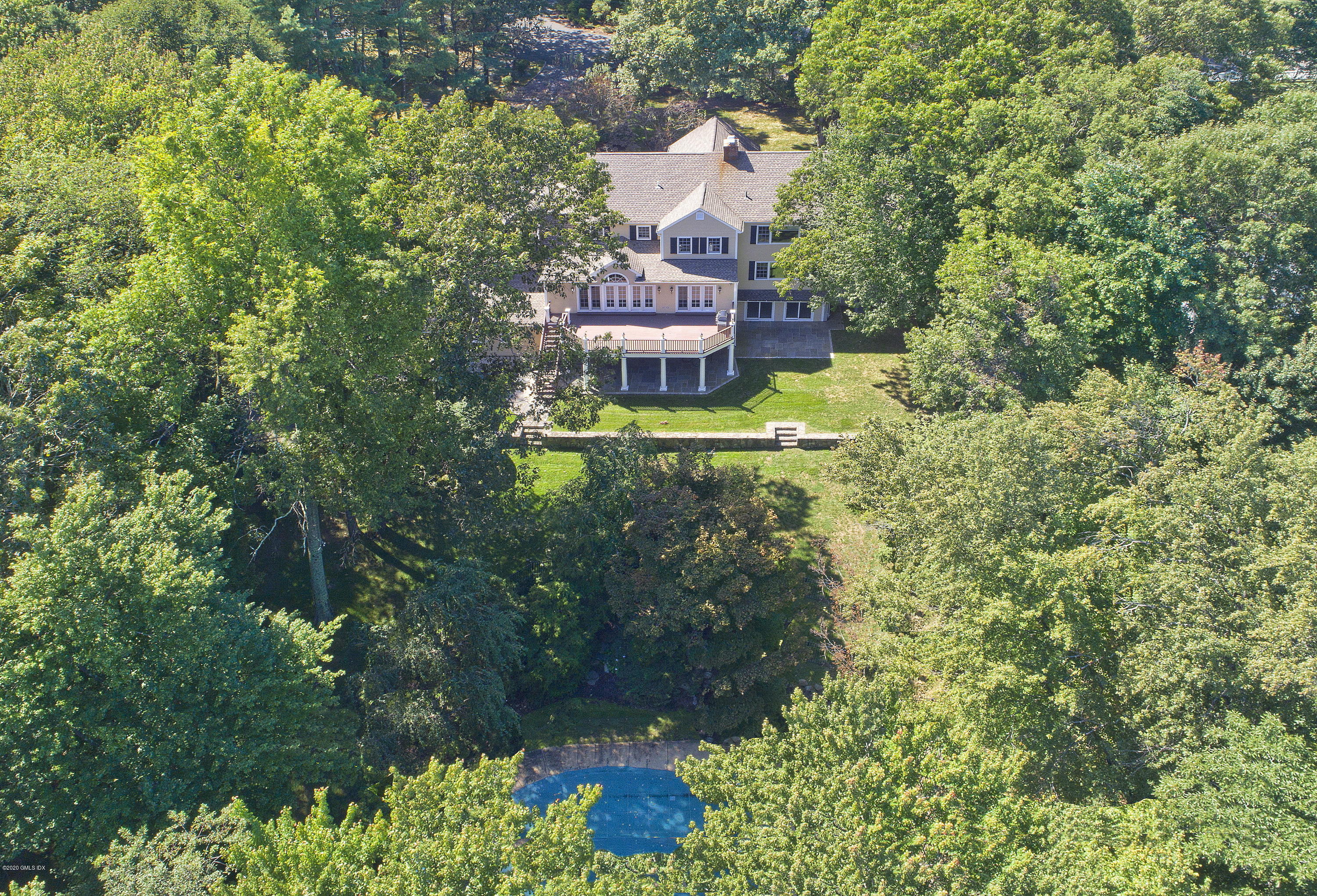 an aerial view of a house with a yard