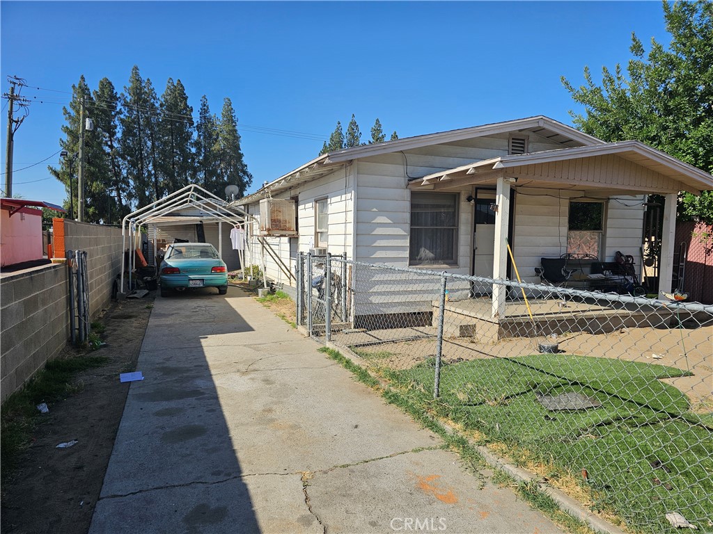 a front view of a house with a yard and potted plants