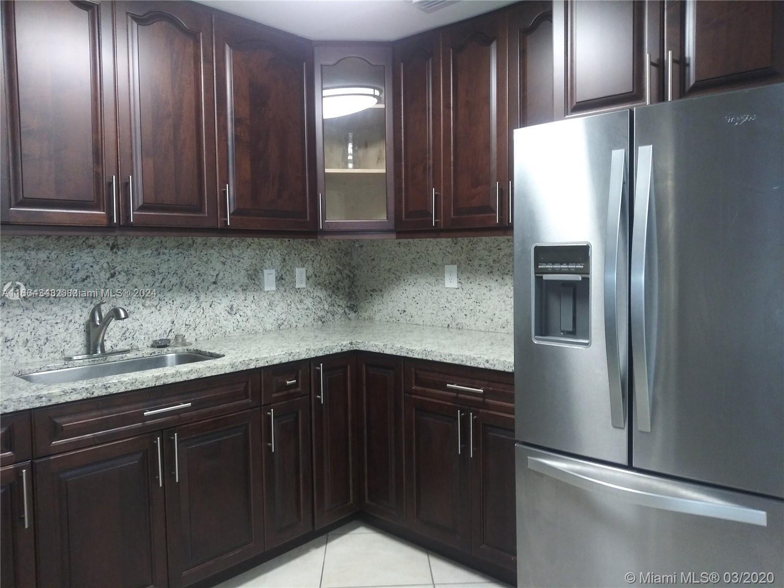 a kitchen with a sink and refrigerator