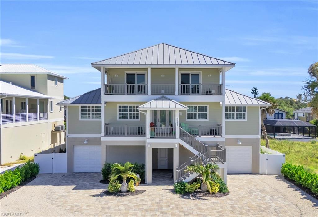 Coastal home featuring a balcony and a garage