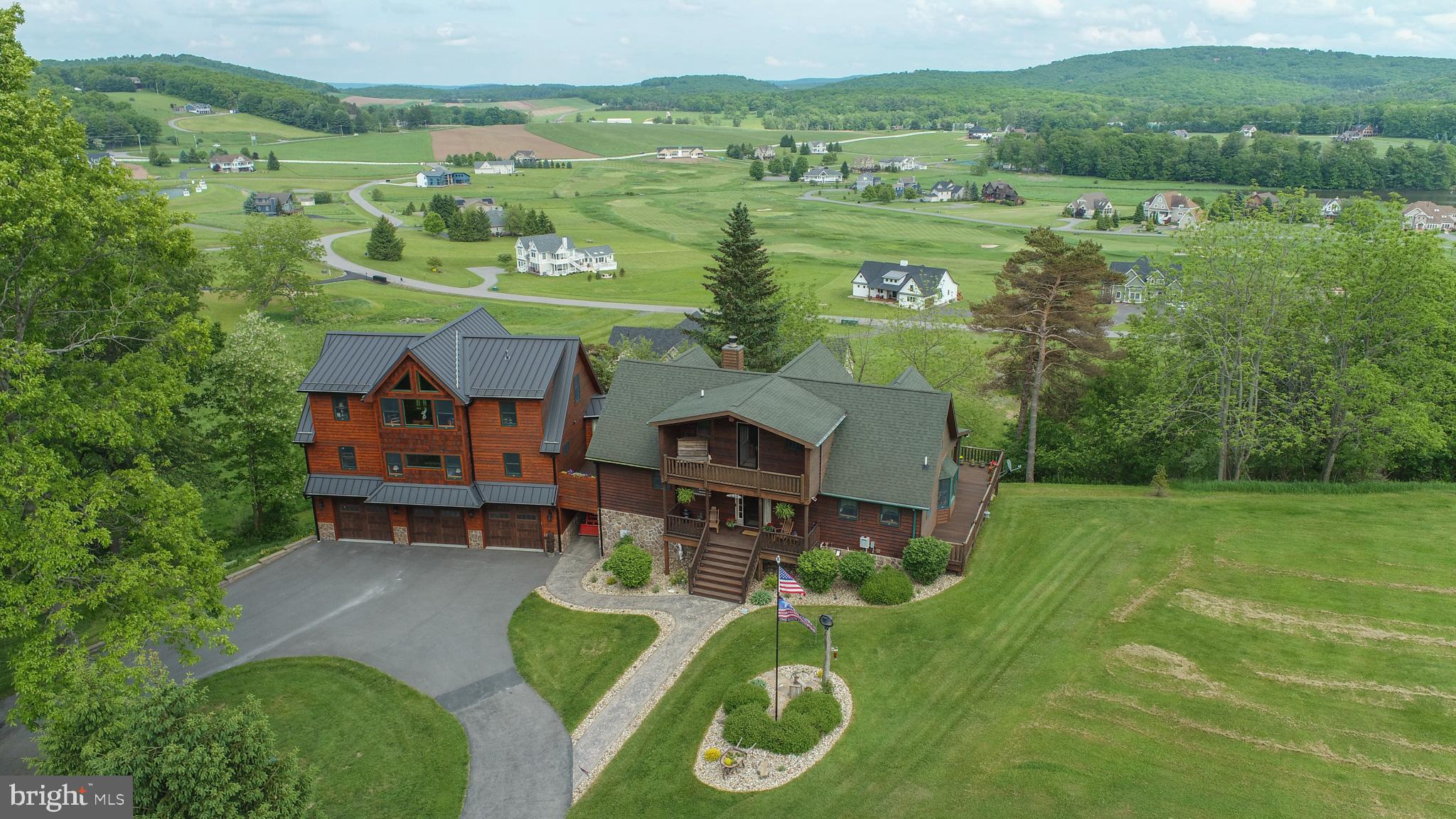 an aerial view of a house with a big yard