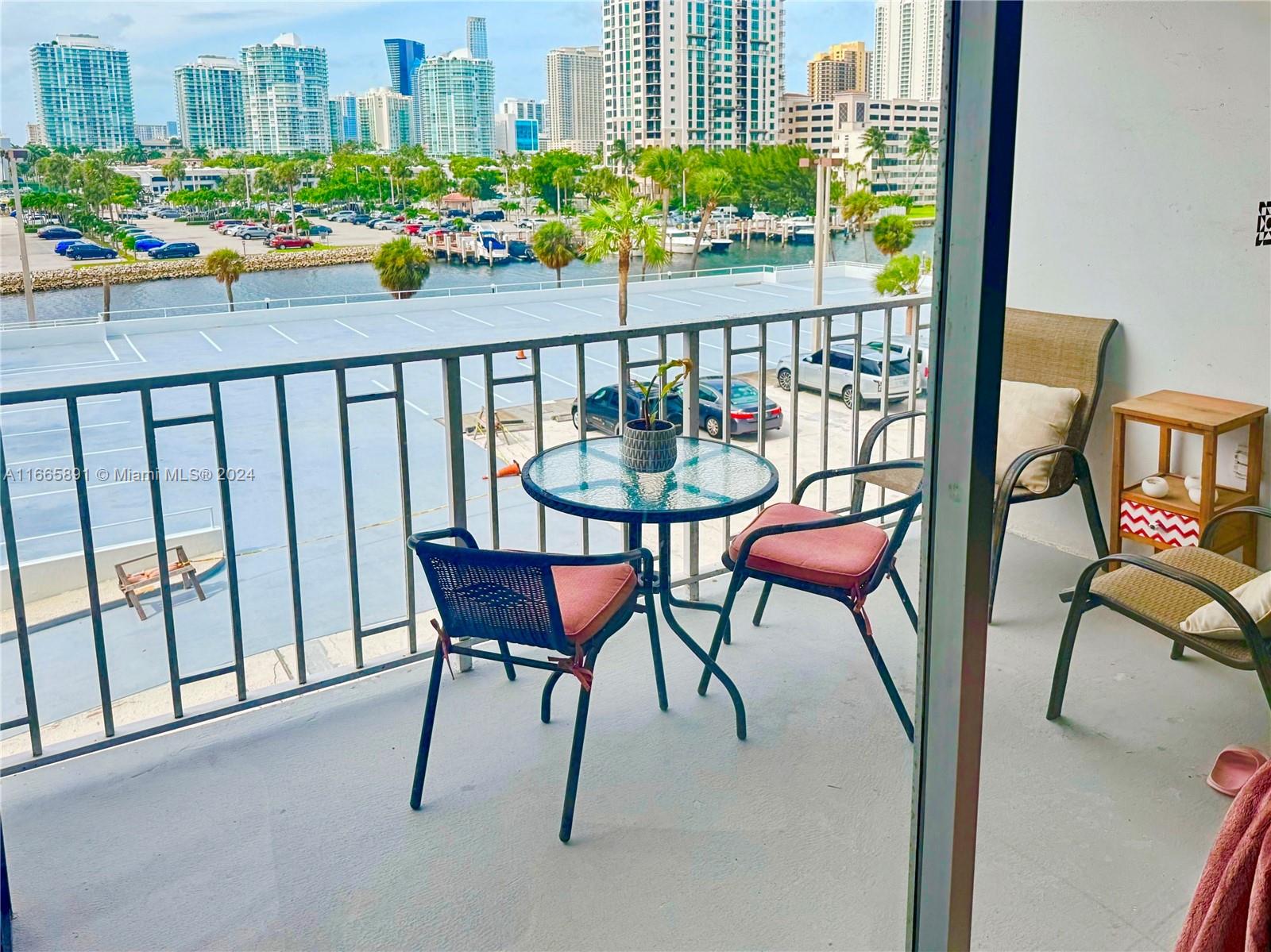 a view of a chairs and table in the balcony