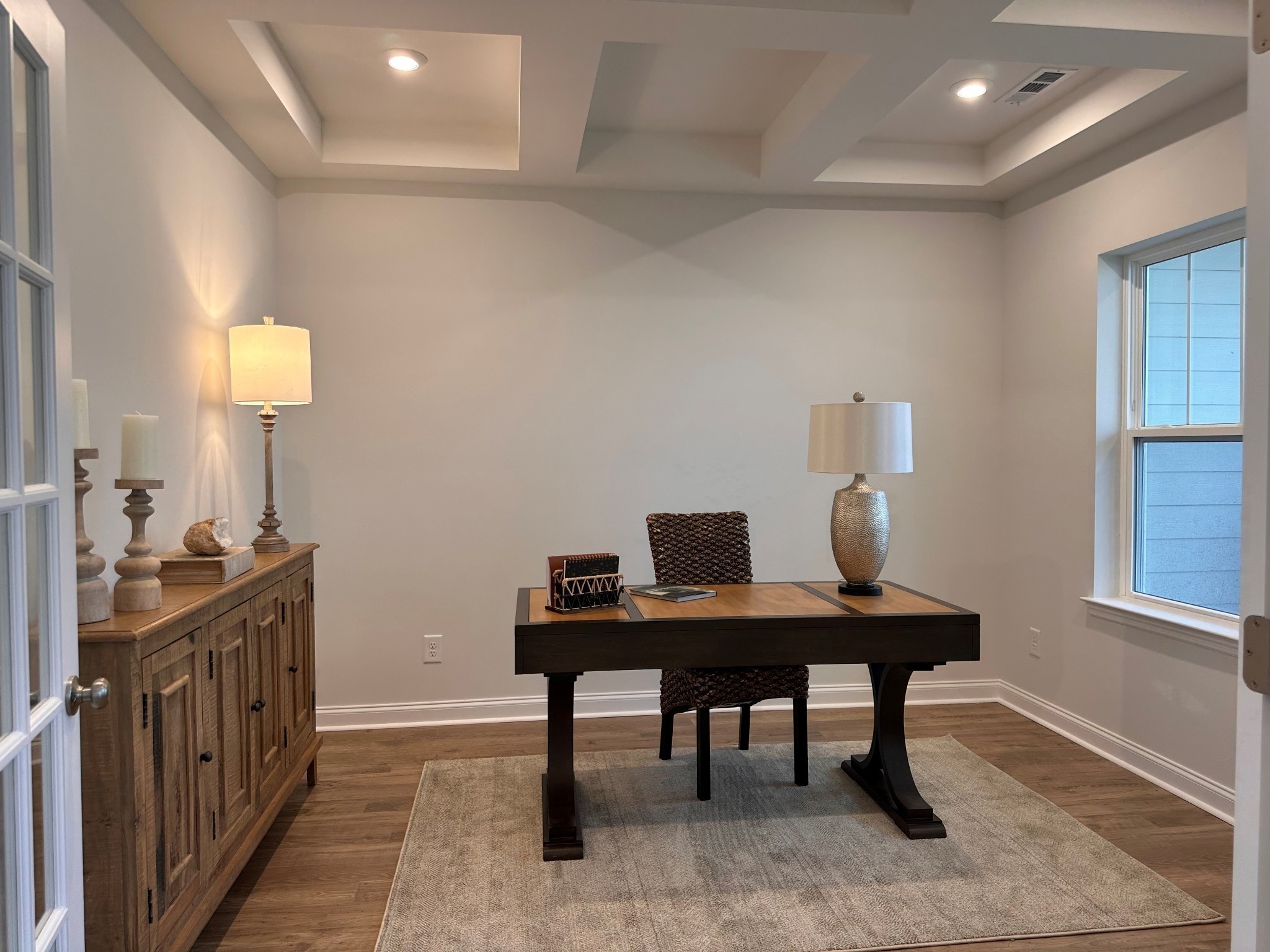 Brand new home with beautiful home office. The Woodland on Homesite 100. Move in Ready four bedroom plan with office and Sunroom on the main level. Notice coffered ceilings and french doors which greet you upon entry.