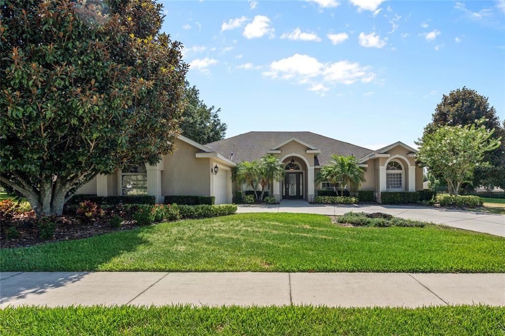 a front view of a house with a yard and garage