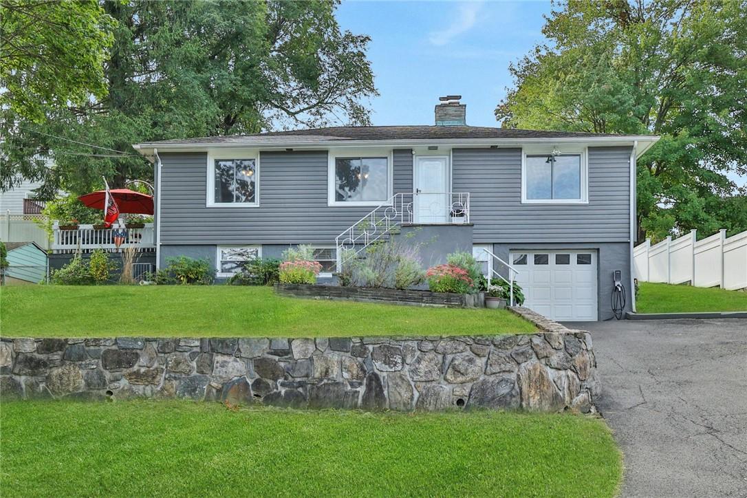 a view of a house with a yard and plants