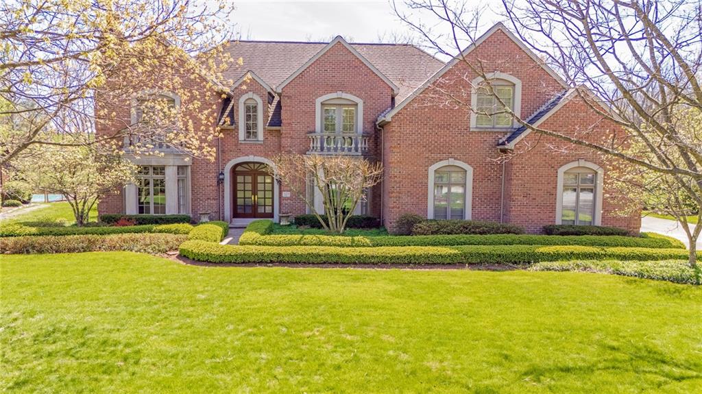 a front view of house with yard and swimming pool