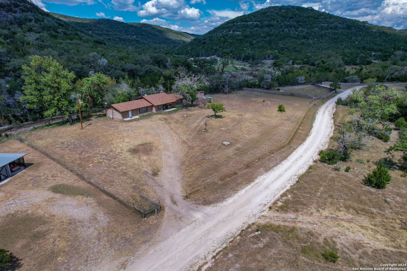 an aerial view of a house with a yard