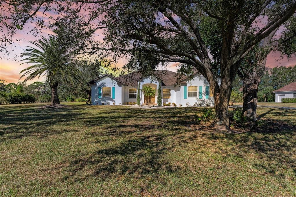 a front view of a house with a garden