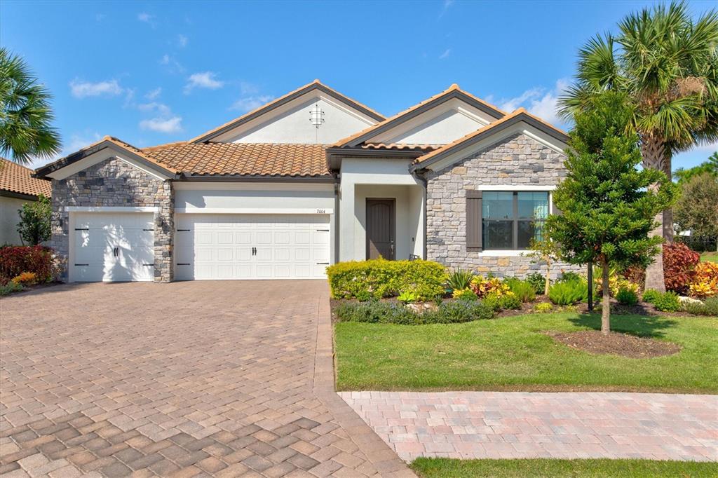 a front view of a house with a yard and garage