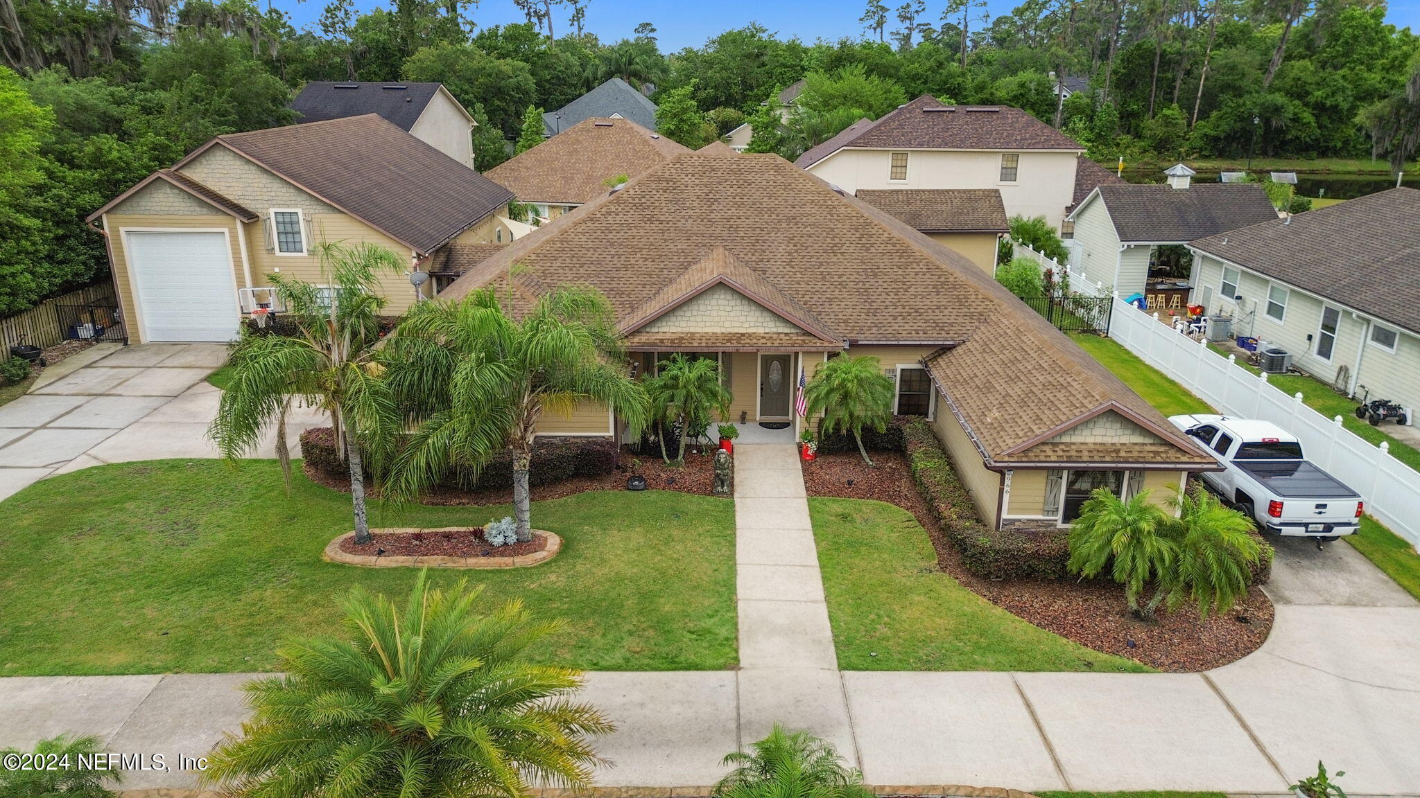 a aerial view of a house with a yard and potted plants