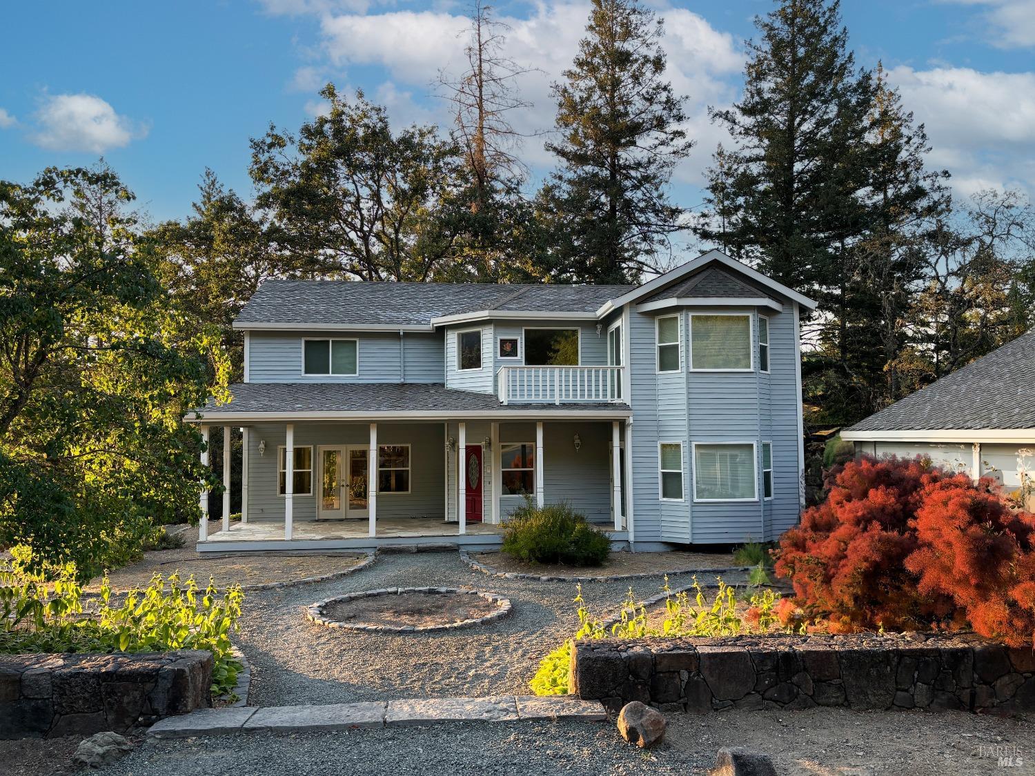 a front view of a house with a yard fire pit and outdoor seating