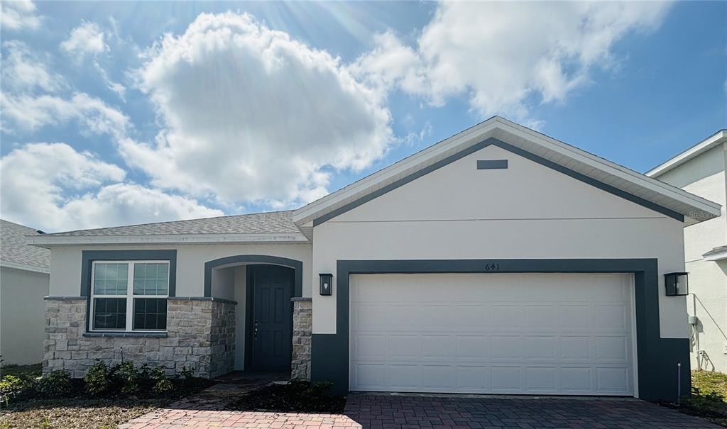 a front view of a house with garage