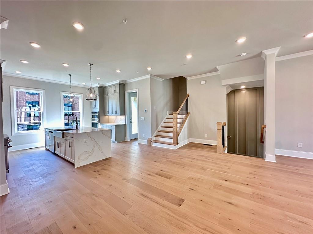 a view of kitchen with refrigerator and wooden floor