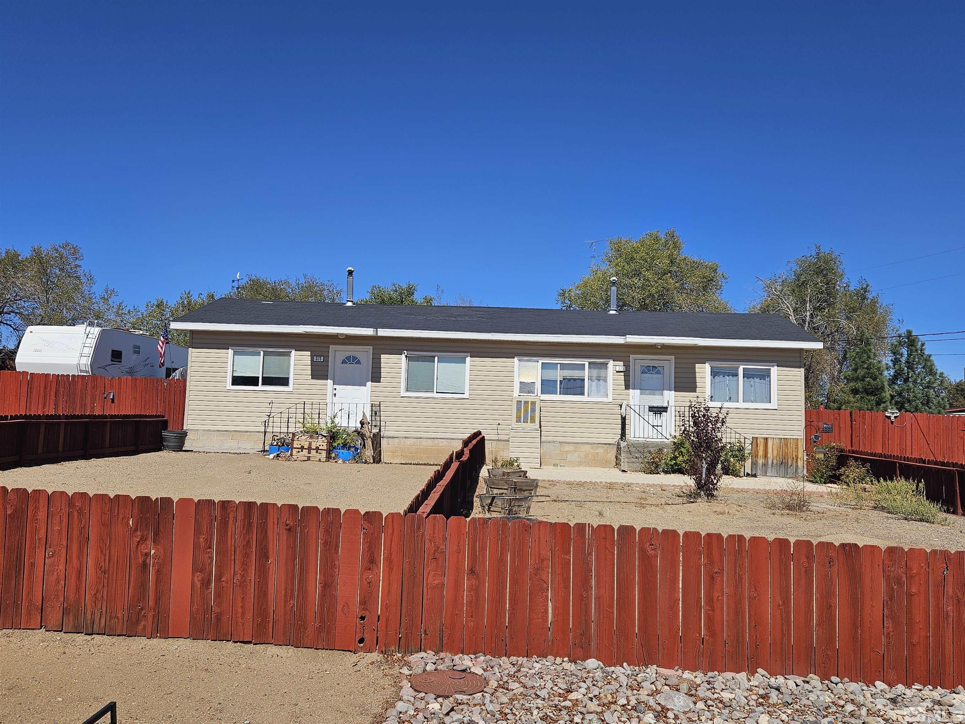 a front view of a house with a yard outdoor seating and kitchen