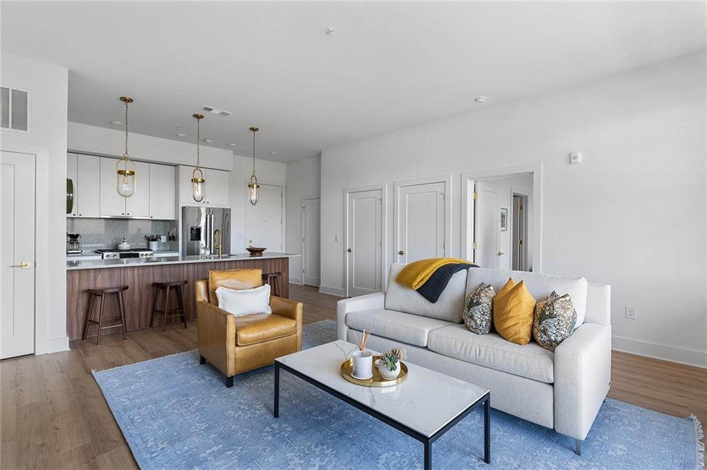 a living room with furniture kitchen view and a dining table