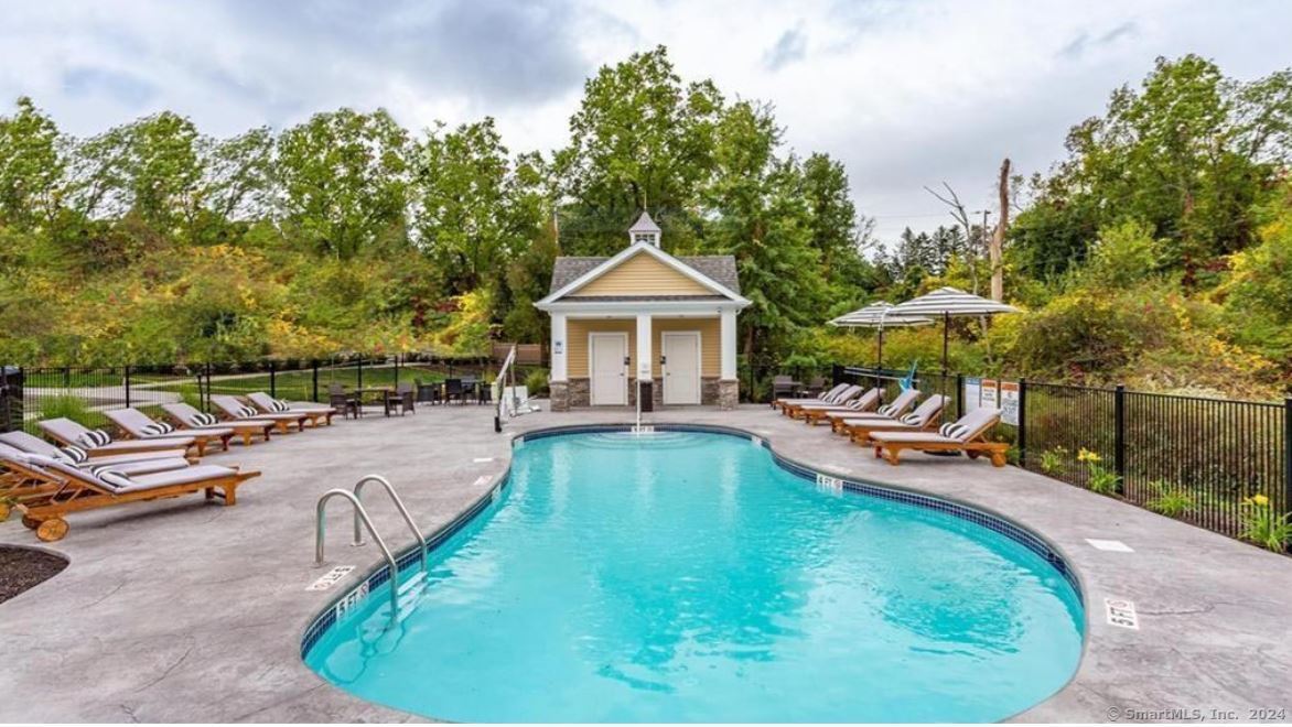 a view of a swimming pool with lounge chairs in patio