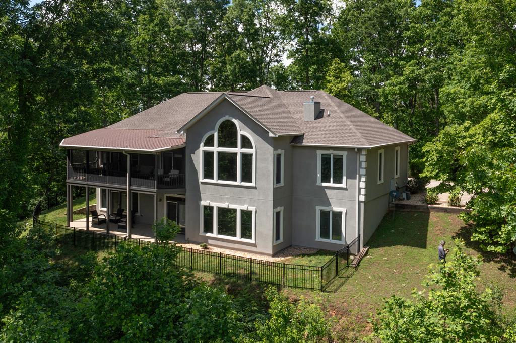 a aerial view of a house with a yard table and chairs