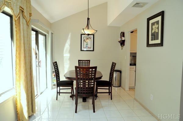 a view of a dining room with furniture and a window