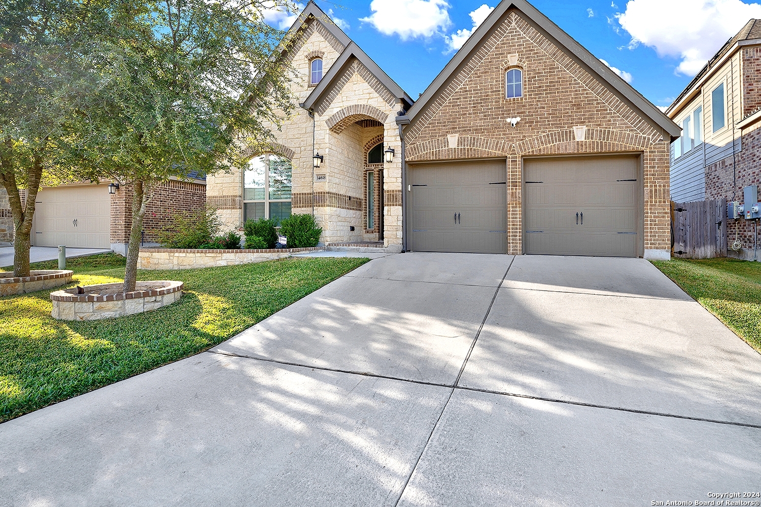 a front view of a house with a yard and garage